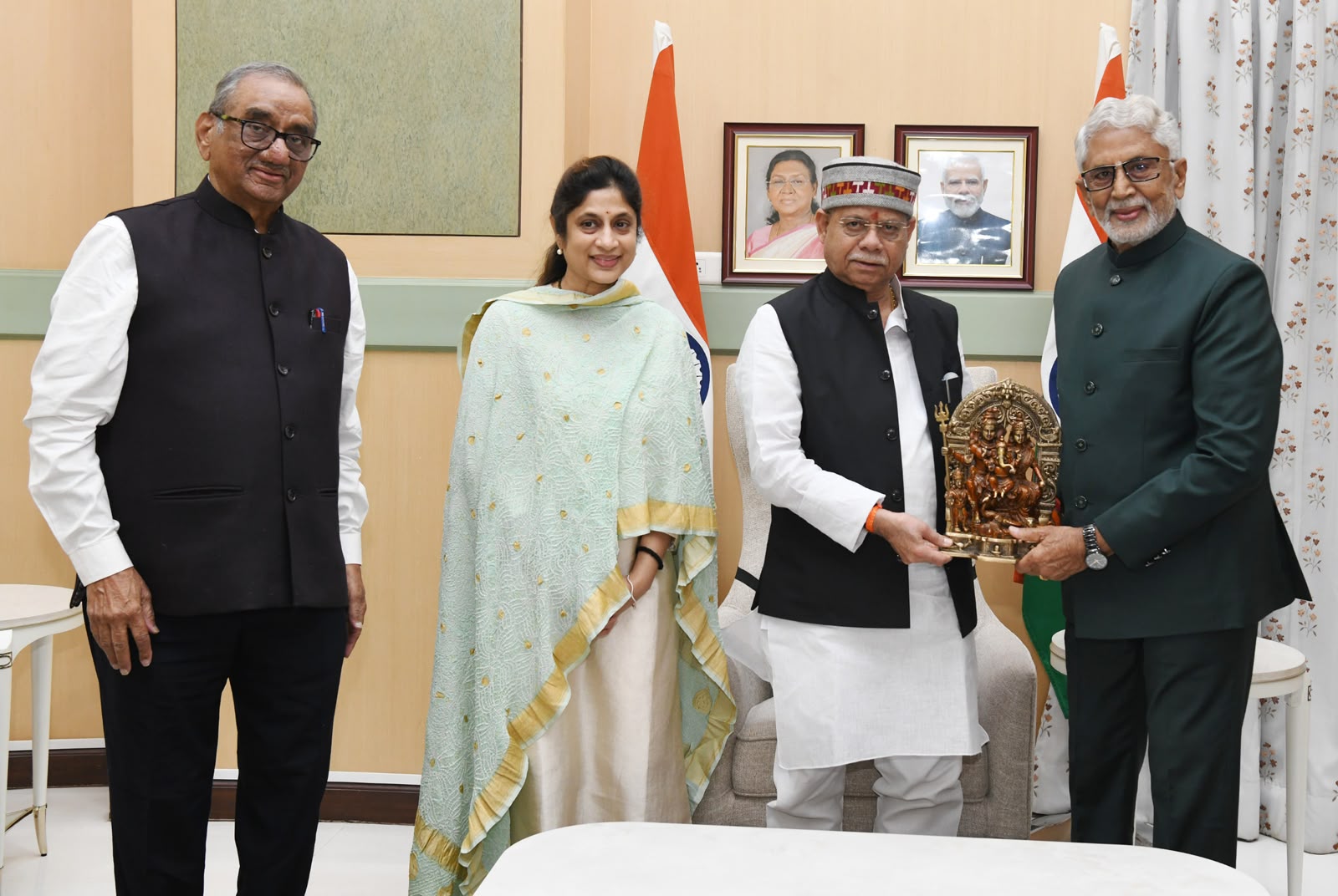 Telangana Governor Shiv Pratap Shukla felicitates Murali Mohan.